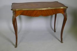 A French marquetry inlaid side table, with shaped top and brass mounts and single frieze drawer,