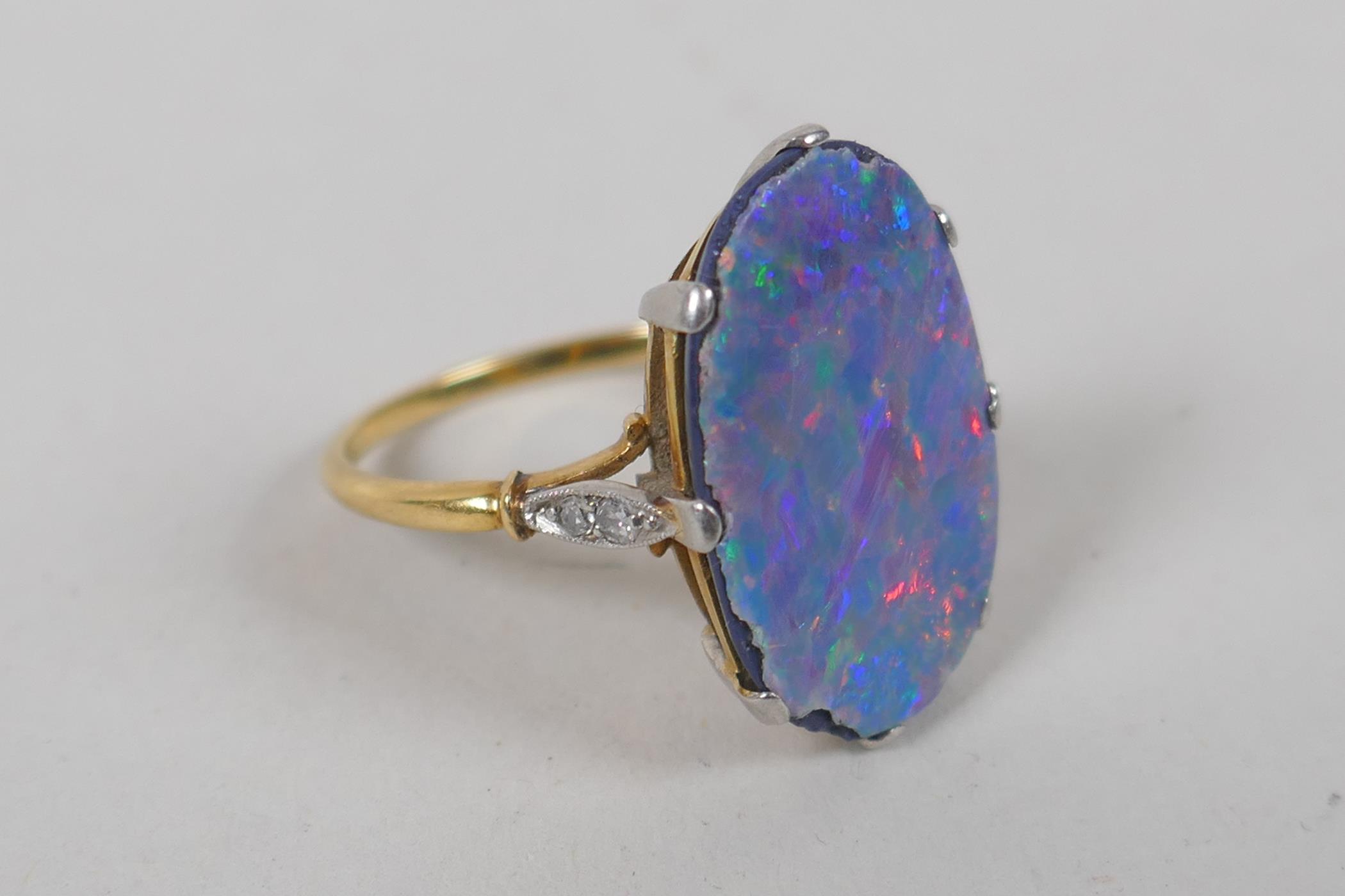 A vintage yellow metal ring set with a fire opal veneered stone and diamond shoulders, together with - Image 2 of 5