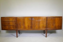 A mid century A.H. McIntosh & Co Ltd rosewood sideboard, with two cupboards flanked by three drawers