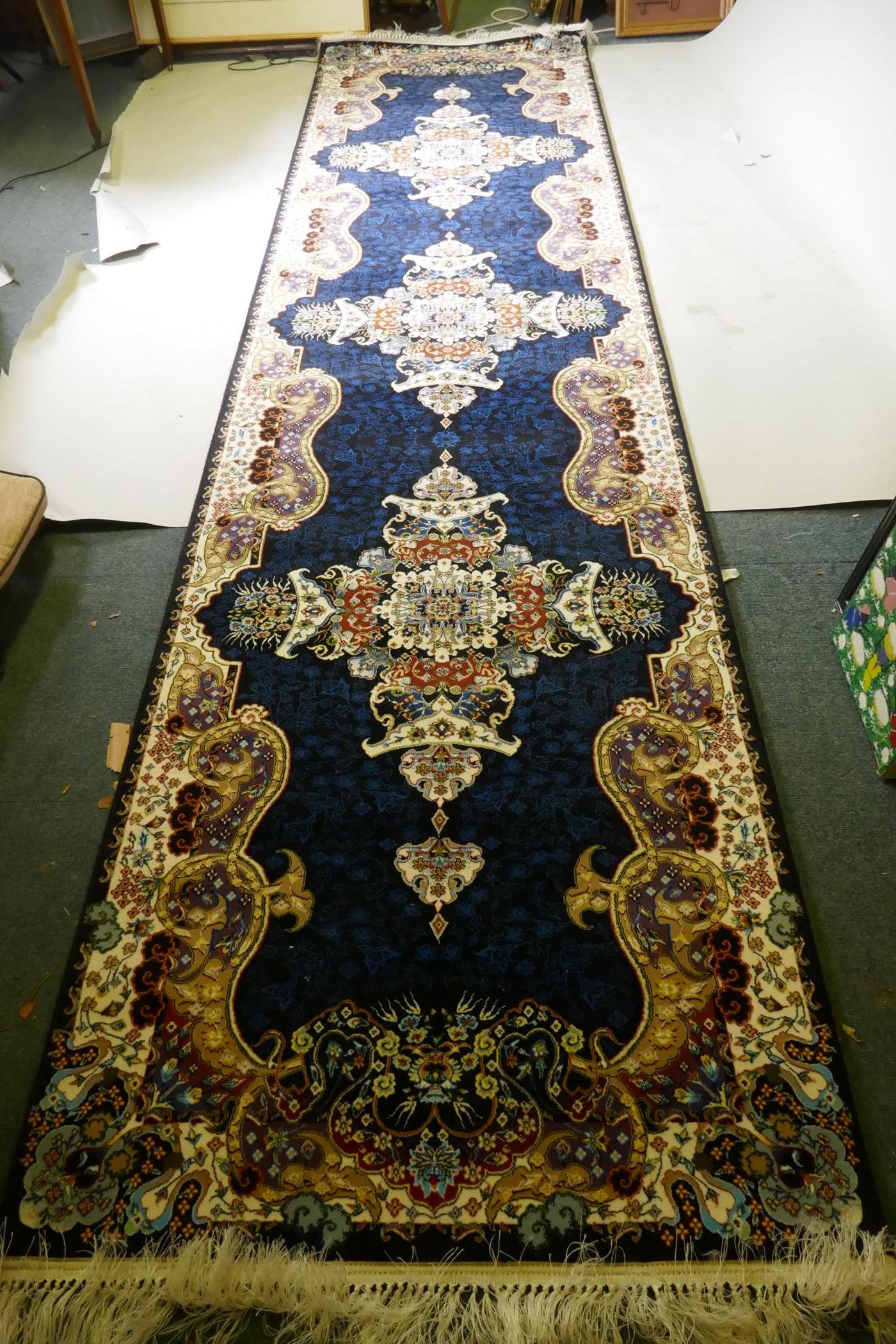 An Iranian fine woven runner with floral medallion design on a deep blue field, 100x  410cm - Image 2 of 8