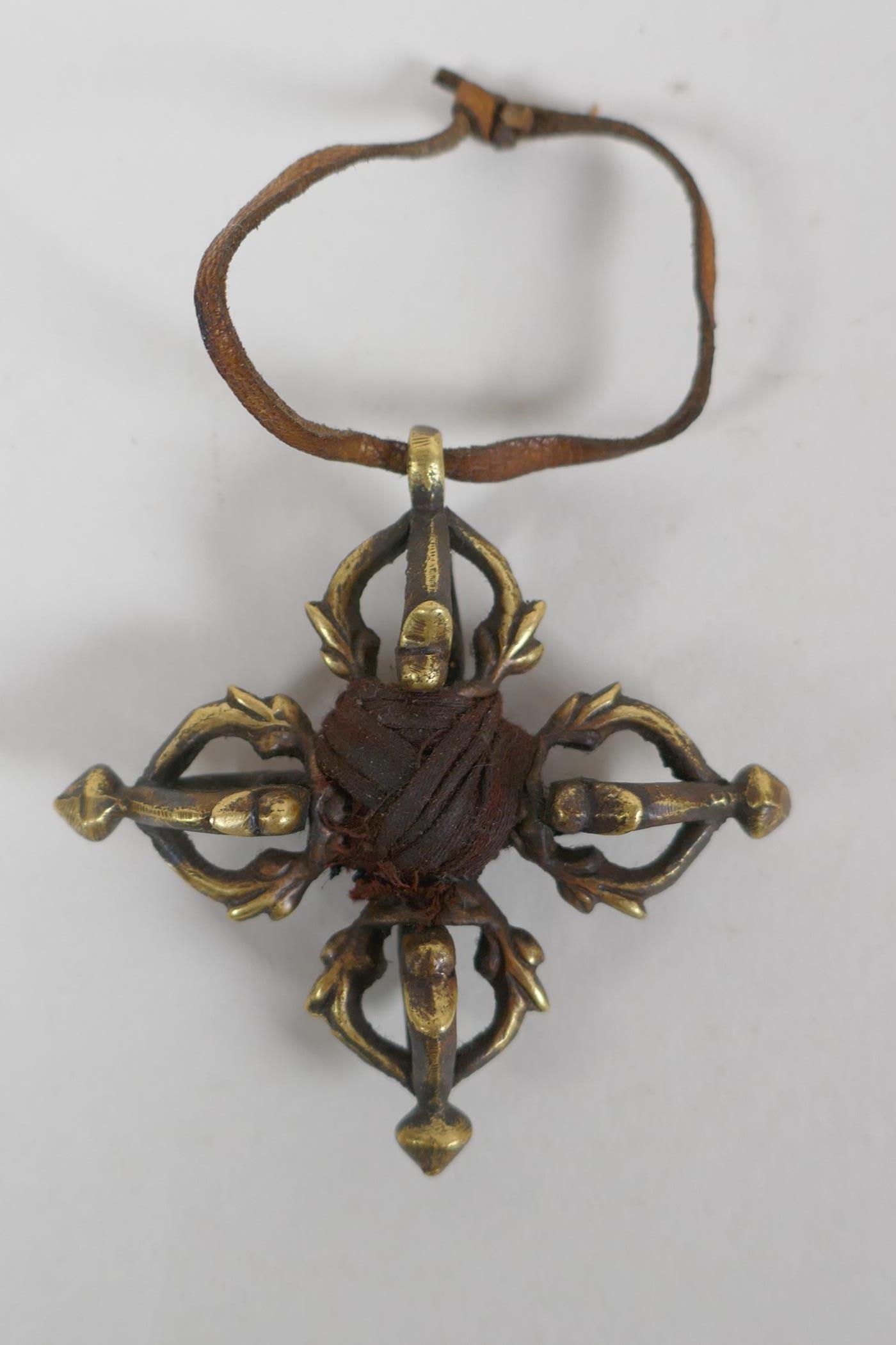 A small Tibetan bronze double vajra pendant and a similar sized vajra pendant, 6 x 6cm - Image 2 of 3