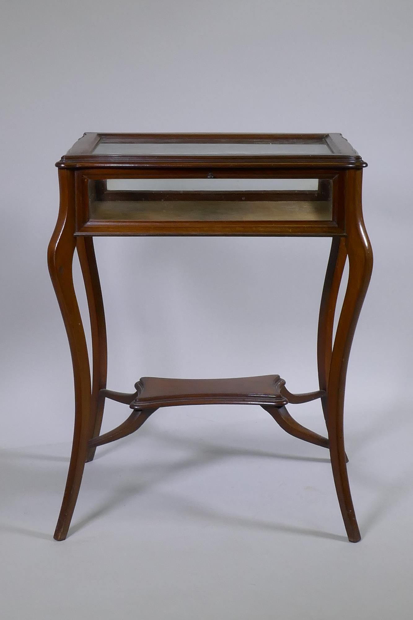 A mahogany bijouterie cabinet with shaped top, raised on splay supports united by an under tier, - Image 2 of 3