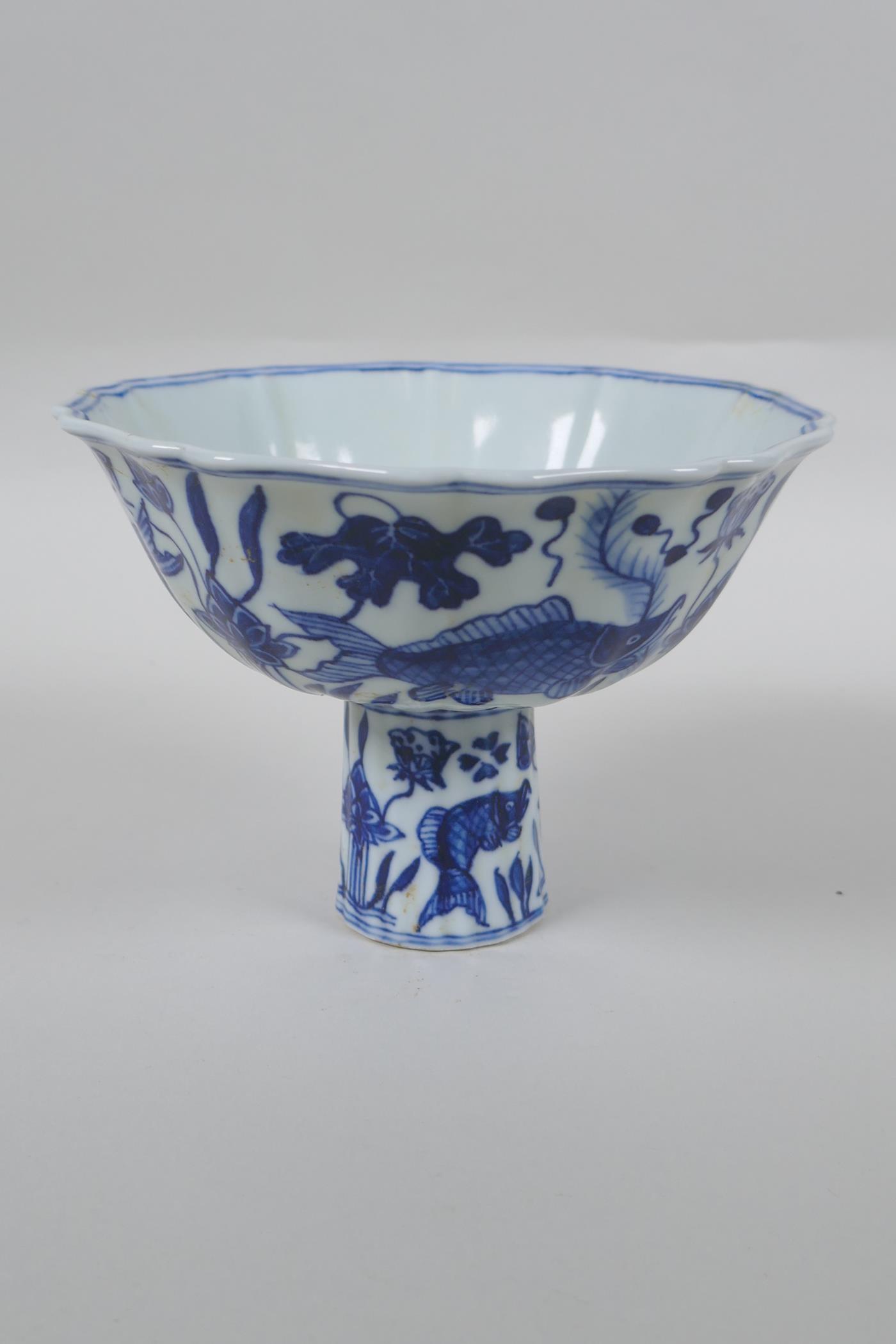 A Chinese blue and white porcelain stem bowl of lobed form decorated with carp in a lotus pond, - Image 3 of 7