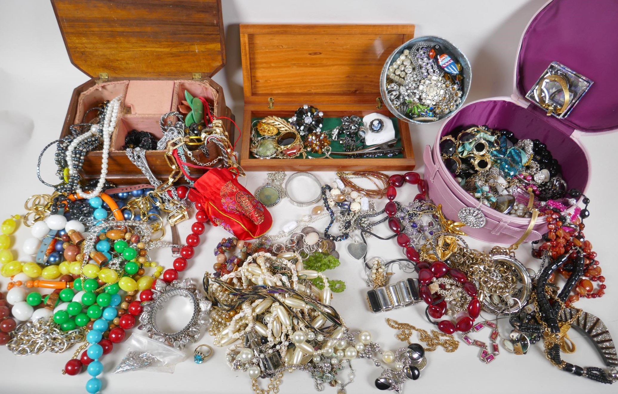 A large quantity of vintage costume jewellery and jewellery boxes, including necklaces, pendants,