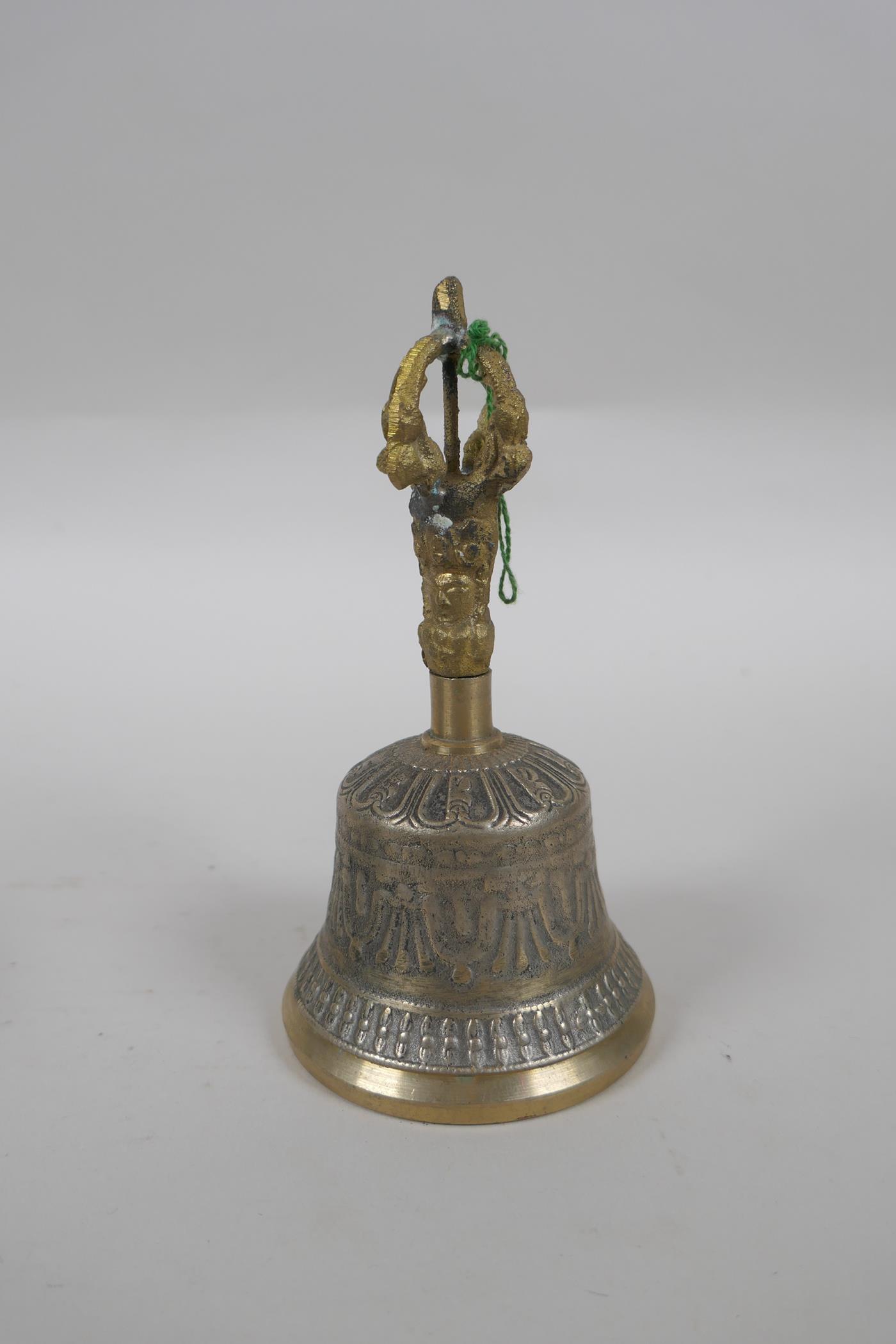 A Tibetan bronze singing bowl and beater with script decoration, a brass ceremonial bell with - Image 5 of 5