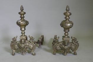 A pair of C19th French silver plated andirons, with fleur de lys and dragon mask decoration, 50cm