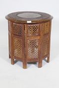 An Indian rosewood Hoshiarpur table with brass inlay and cared floral decoration, with folding
