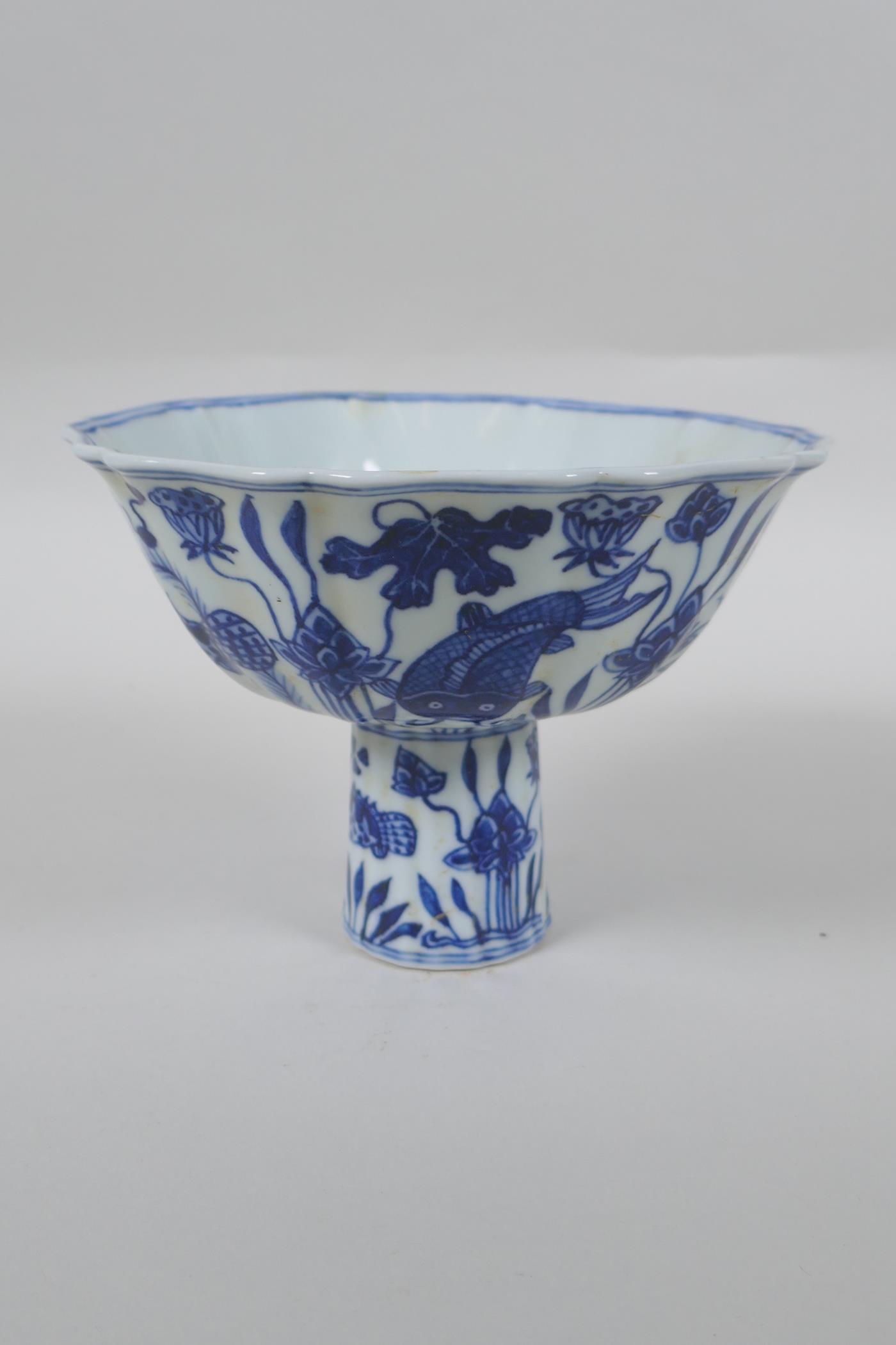 A Chinese blue and white porcelain stem bowl of lobed form decorated with carp in a lotus pond, - Image 2 of 7