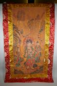 A Tibetan printed thangka with a silk mount, 110 x 65cm