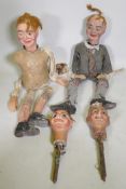 Four early C20th ventriloquist's dummy heads, paper mache with glass eyes, and two associated