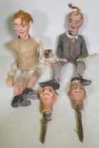 Four early C20th ventriloquist's dummy heads, paper mache with glass eyes, and two associated