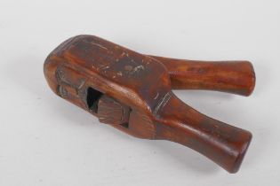 An antique carved wood nut cracker, 18cm long