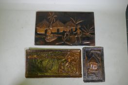 Three African embossed copper decorative panels depicting figures in landscapes, two signed '