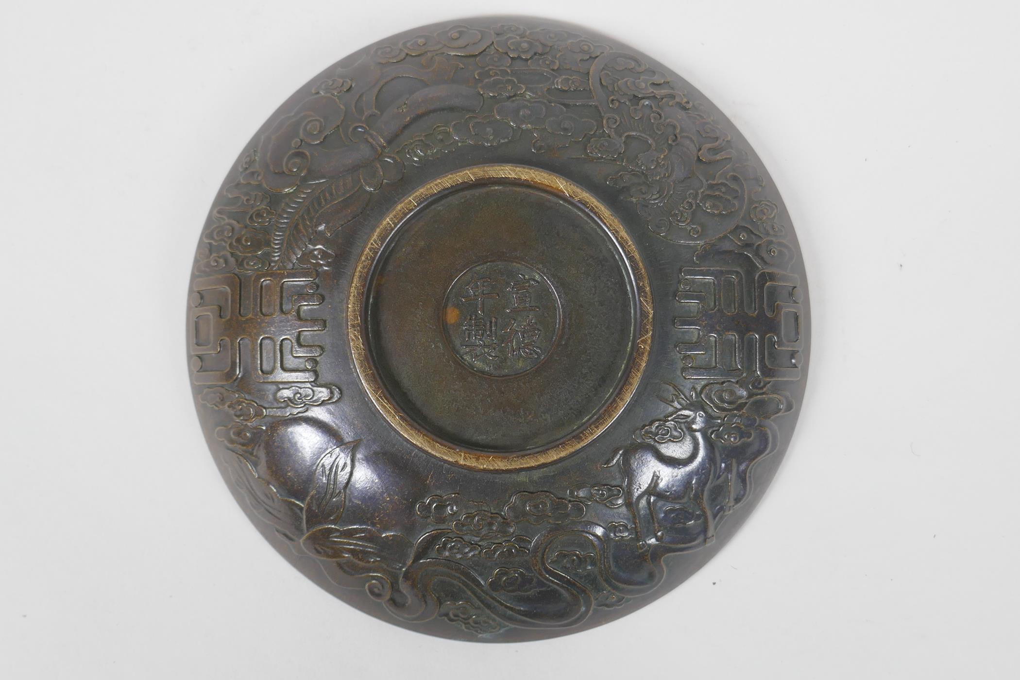 A Chinese bronze dish with raised kylin decoration, Xuande 4 character mark to base, 18cm diameter - Image 4 of 5