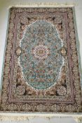 A fine woven full pile Iranian carpet with traditional floral medallion design on a turquoise field,