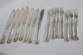 A matching part set of three solid silver fish knives and forks and a set of four in King Edward
