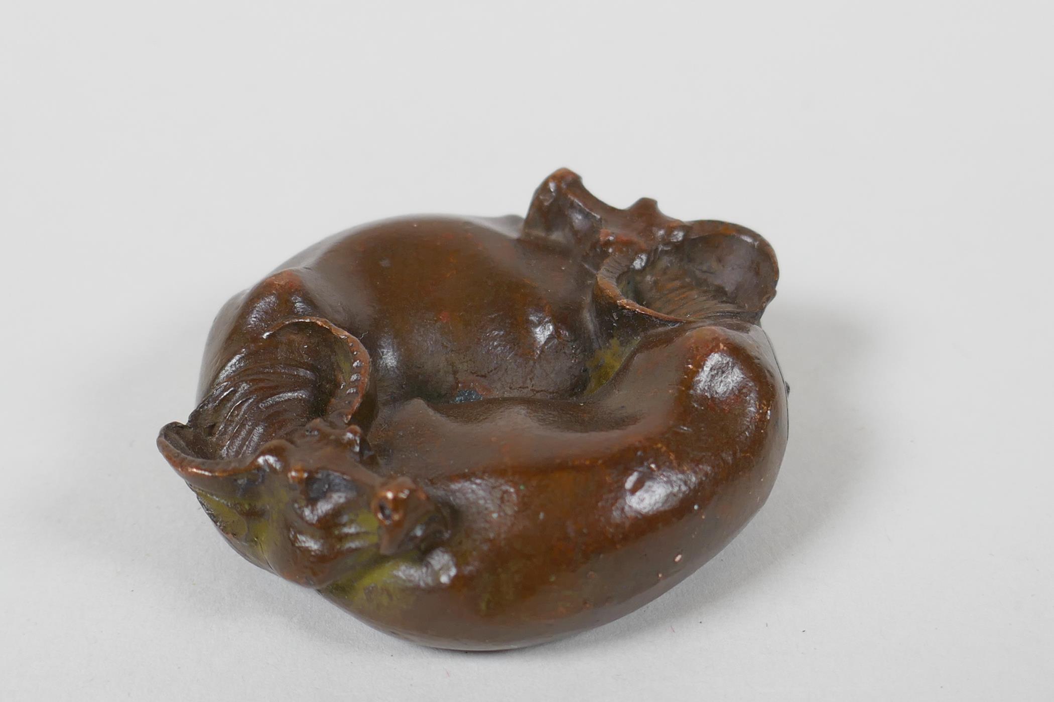 An oriental cast bronze rondel in the form of two water buffalo and a Yin Yang emblem, 6cm diameter - Image 2 of 3
