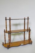 A C19th satinwood hanging wall shelf with thee shaped tiers united by faux bamboo turned supports