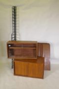 A mid century mahogany Ladderax style wall system of two cabinets and shelves, 178cm high