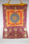 A Tibetan hand painted mandala within a silk mount, 66 x 52cm