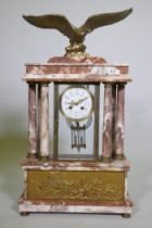 A C19th French rouge marble clock with bronze mounts, the case surmounted by an eagle signed L.