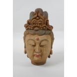 A Chinese carved, painted and distressed wood Quan Yin bust, 22cm high