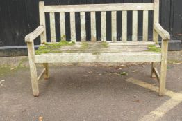 A weathered teak garden bench