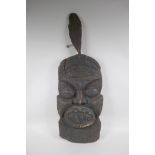 An antique African carved hardwood wall mask, 74cm high x 26cm wide