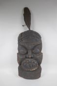 An antique African carved hardwood wall mask, 74cm high x 26cm wide
