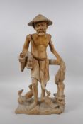 An oriental carved wood figure of a farmer surrounded by ducks, 46cm high