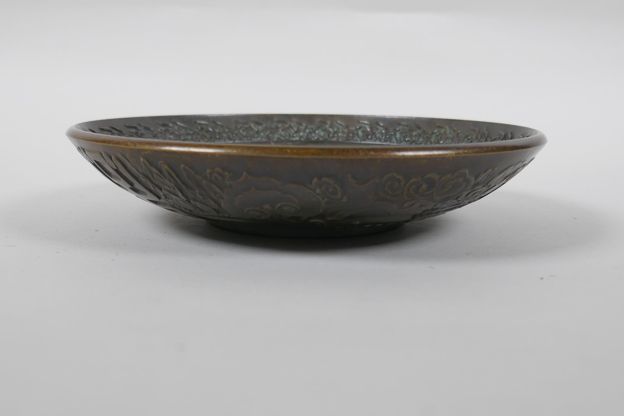 A Chinese bronze dish with raised kylin decoration, Xuande 4 character mark to base, 18cm diameter - Image 3 of 5