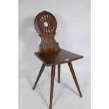 A C19th continental walnut hall chair with carved back, dated 1858 and initialled