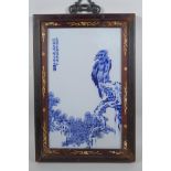 A Chinese blue and white panel depicting an eagle in an inlaid hardwood frame, 30 x 44cm