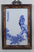 A Chinese blue and white panel depicting an eagle in an inlaid hardwood frame, 30 x 44cm