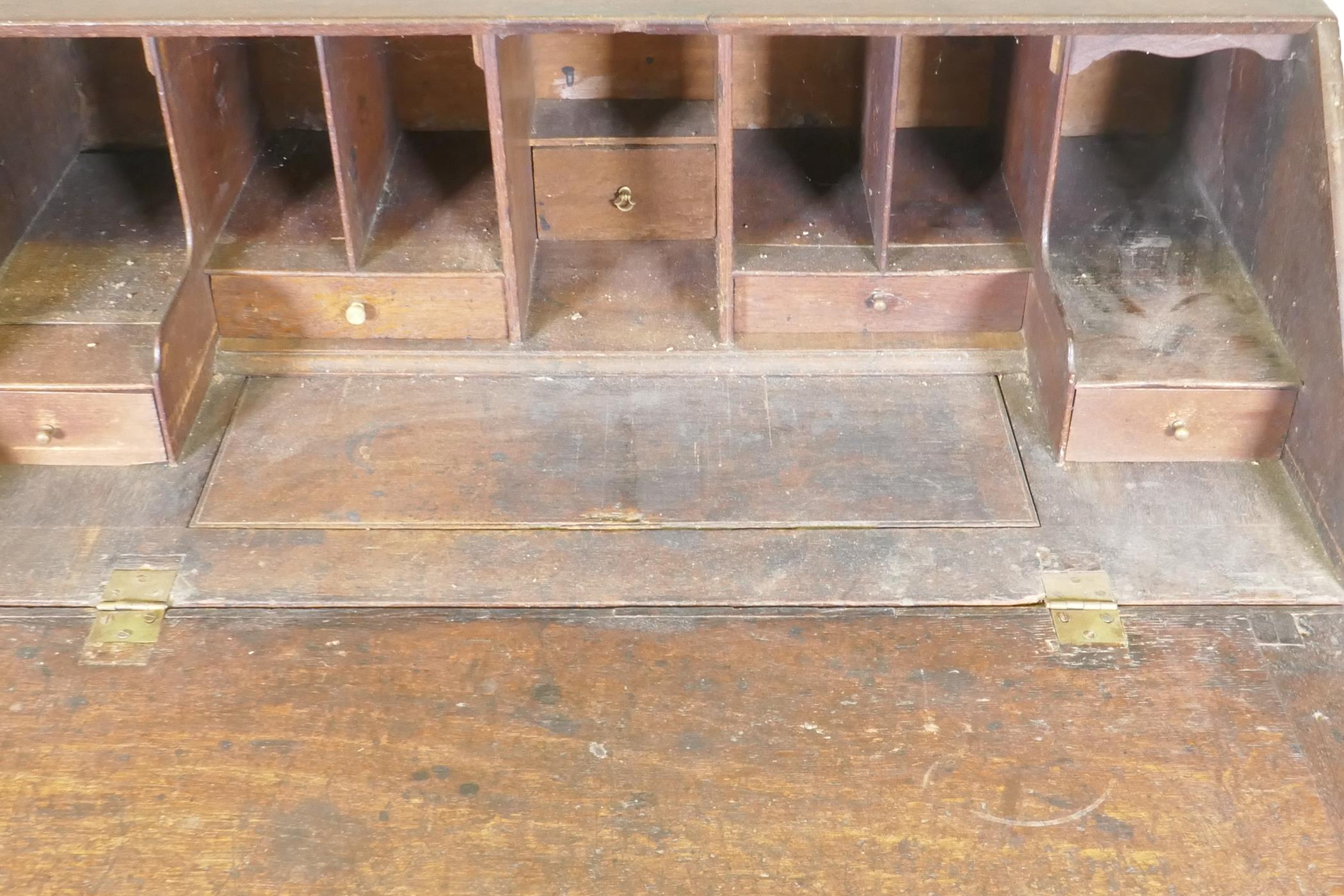 An early Georgian oak fall front bureau, the interior with drawers and pigeon holes and slide - Image 2 of 7