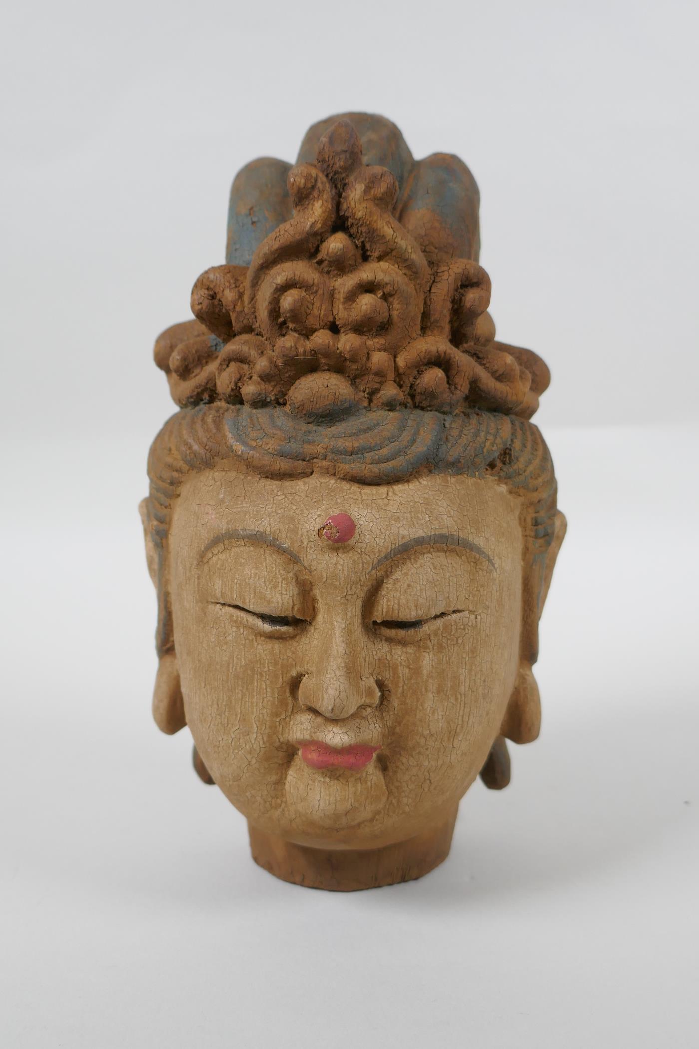 A Chinese carved, painted and distressed wood Quan Yin bust, 22cm high