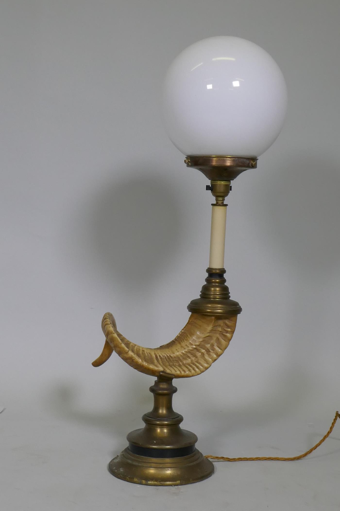 A table lamp in the form of a ram's horn, with brass mounts and opaline glass shade, 68cm high - Image 2 of 2