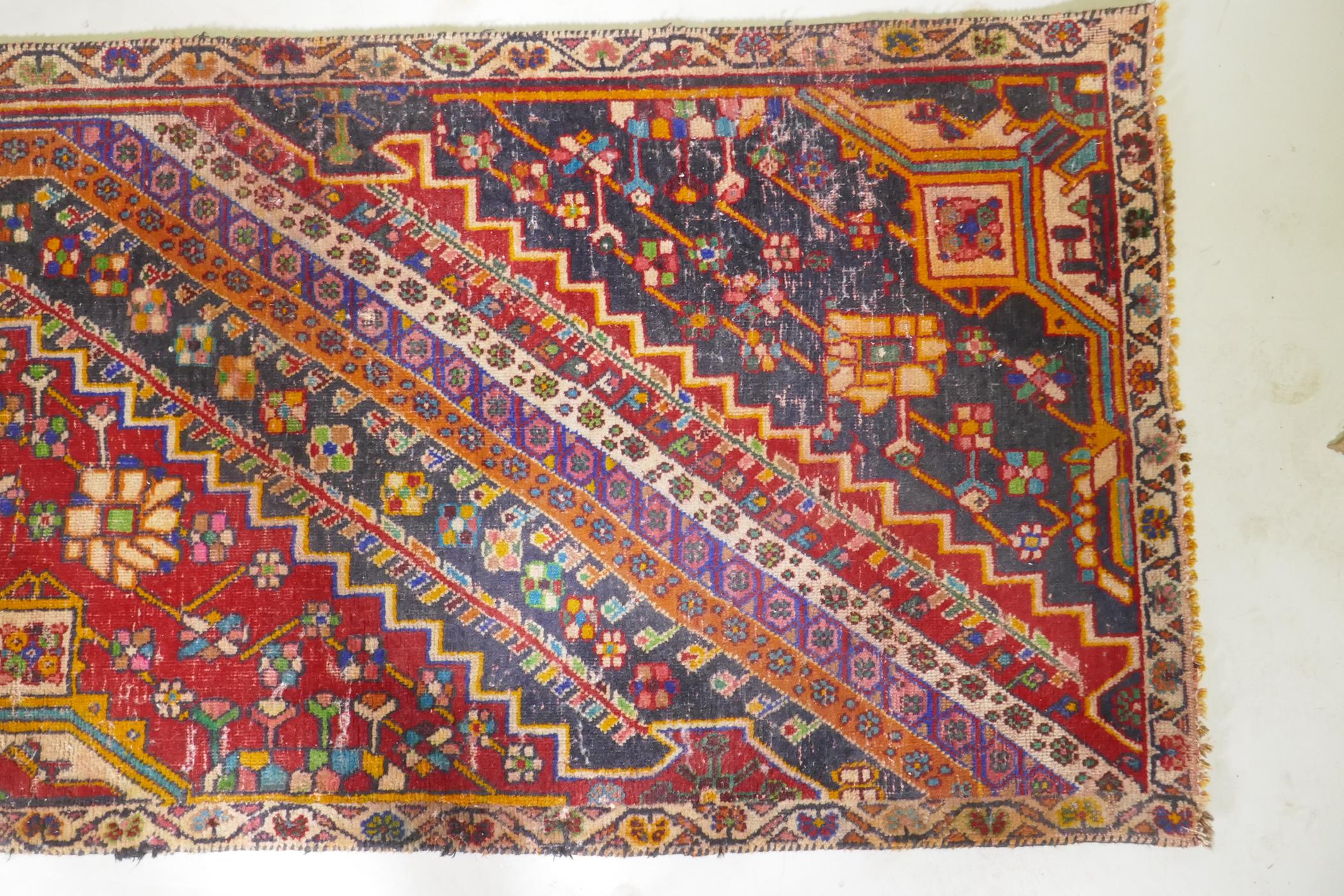 A Kashkai wool runner with geometric designs on a red field, 84 x 174 - Image 2 of 7