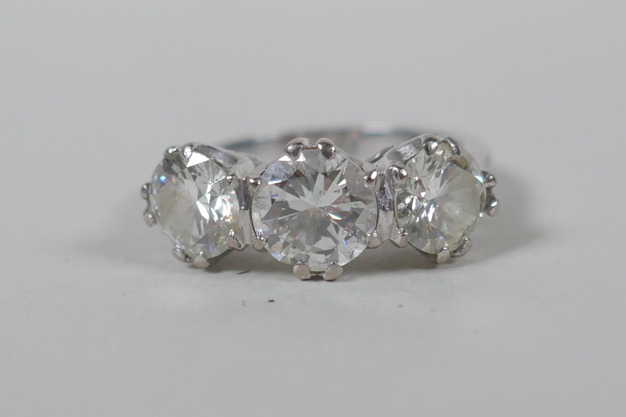A platinum set three brilliant cut diamond ring, the central stone approx 0.95ct, flanking two - Image 5 of 8