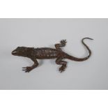 A Japanese style bronze okimono lizard, 15cm long, impress mark to belly