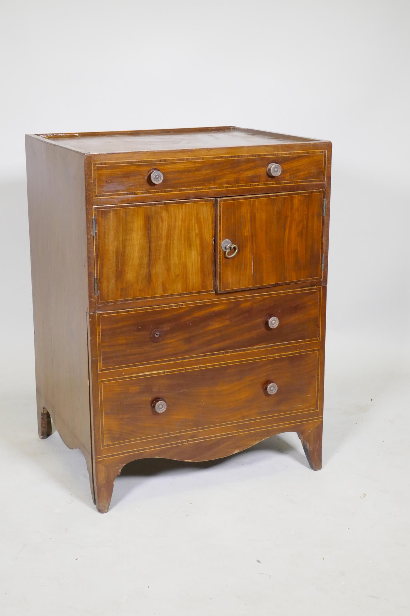 A Georgian mahogany commode/dressing chest with lift up top, two cupboards and pull out bottom
