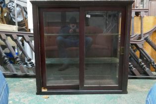An early C20th shop cabinet with sliding doors and glass shelves, 99 x 38 x 96cm