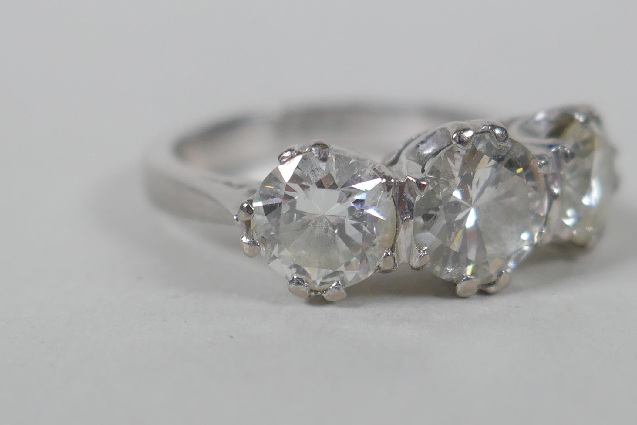 A platinum set three brilliant cut diamond ring, the central stone approx 0.95ct, flanking two - Image 7 of 8