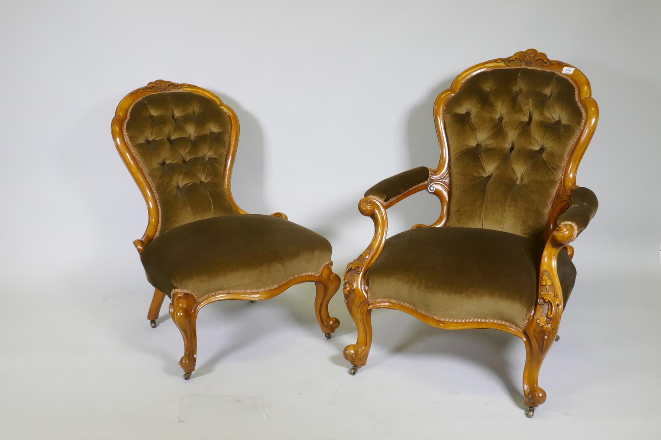 A Victorian gentleman's walnut show frame armchair with carved decoration, raised on cabriole