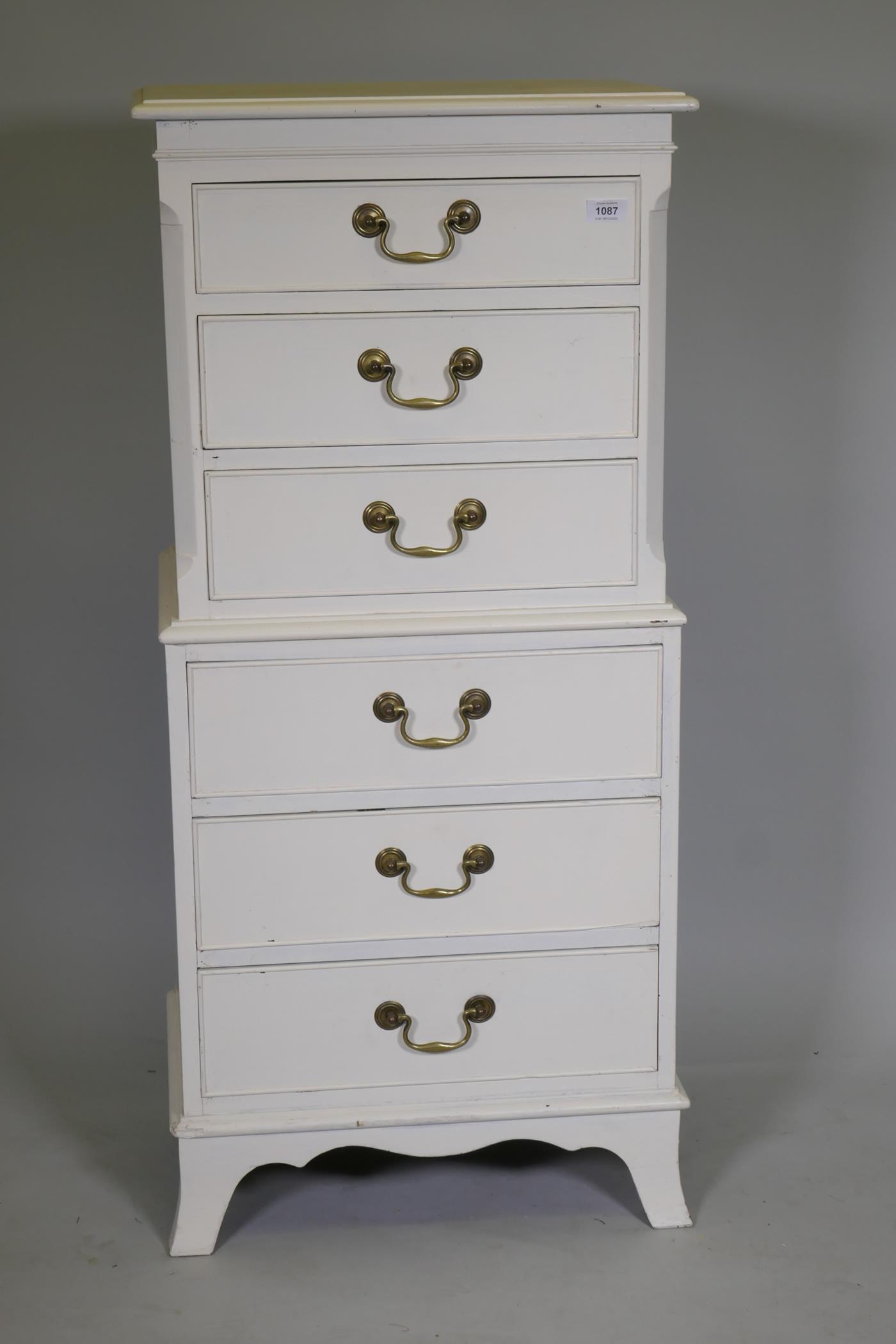 A painted tallboy chest of six drawers with brass swan neck handles, raised on swept supports, 52