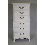 A painted tallboy chest of six drawers with brass swan neck handles, raised on swept supports, 52