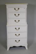 A painted tallboy chest of six drawers with brass swan neck handles, raised on swept supports, 52