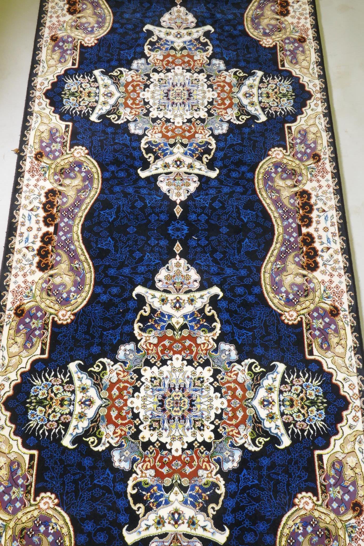 An Iranian fine woven runner with floral medallion design on a deep blue field, 100x  410cm - Image 6 of 8