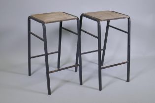 A pair of vintage industrial laboratory stools, with steel frames and ply seats, 52cm high