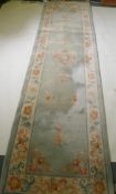 A Chinese wool runner, 86 x 317cm